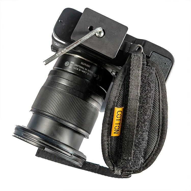 Cotton carrier hand camera strap attaching to bottom of camera body