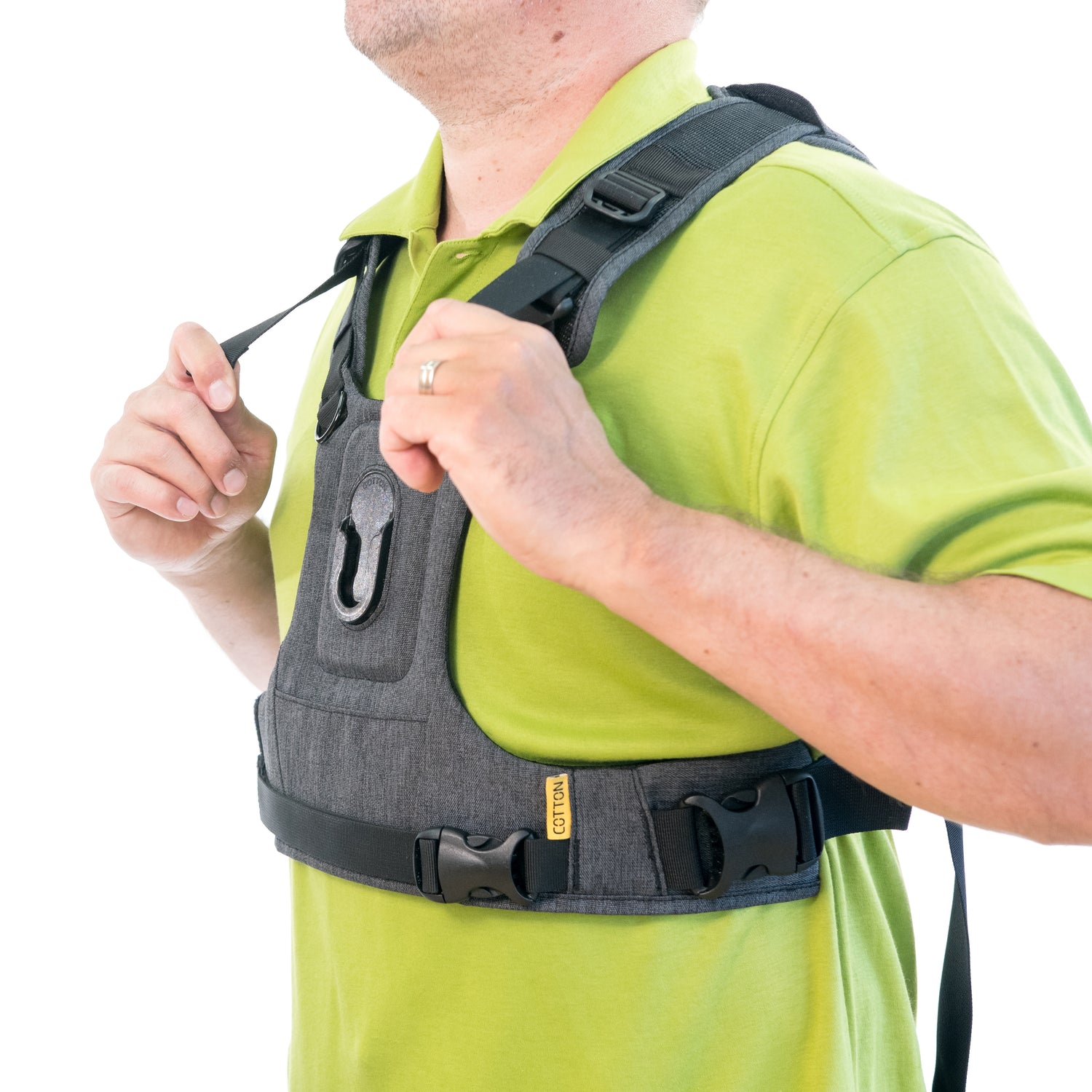 Man demonstrating how to tighten the straps on a G3 camera harness