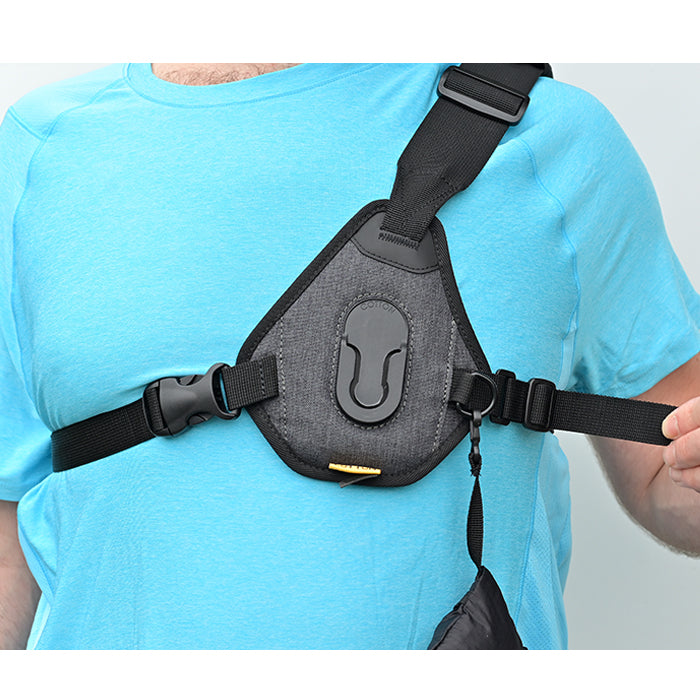 Man demonstrating how to put on a CCS Skout G2 camera sling harness