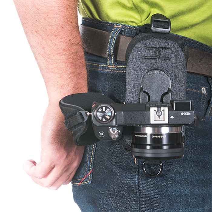 CCS G3 Grey Strapshot camera holster attached to a man's belt while holding a camera