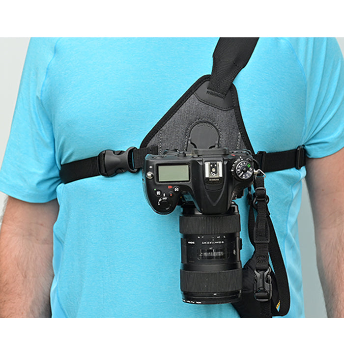 Camera sling harness being worn with a camera attached